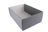 An empty rectangular cardboard box with a matte gray exterior and a white interior, photographed on a white fabric surface.